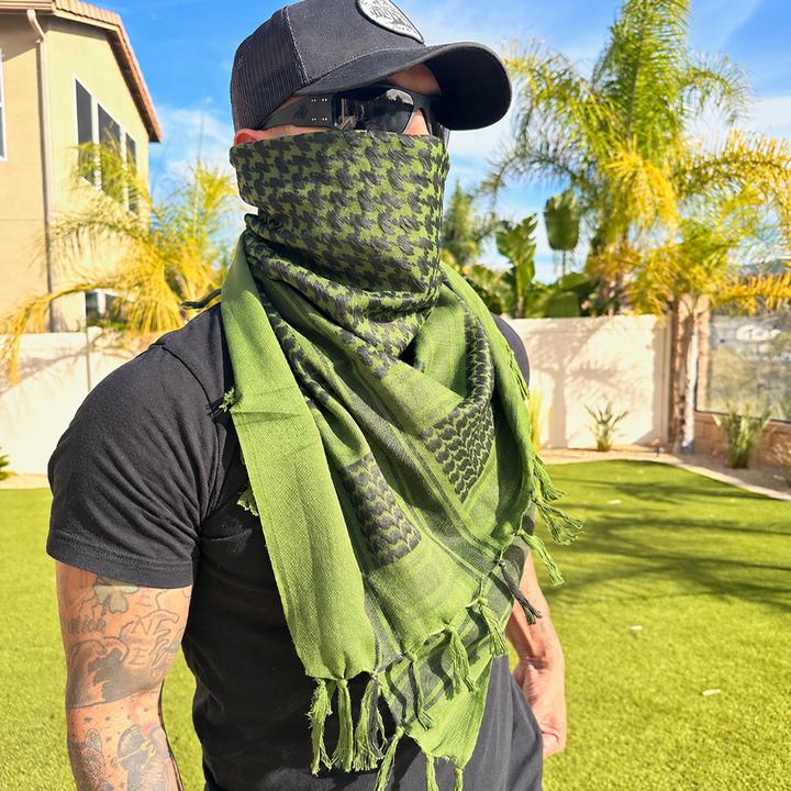 green shemagh scarf worn outdoors with plain clothing