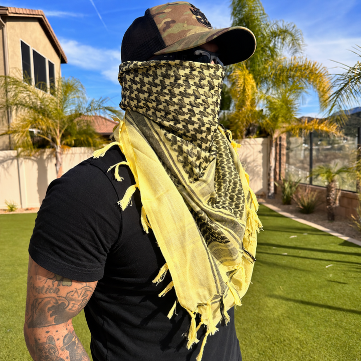 sand shemagh scarf worn outdoors with plain clothing